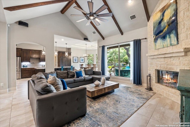 26815 Duet Dr, San Antonio, TX 78260 - living area featuring high vaulted ceiling, ceiling fan, a stone fireplace, beam ceiling, and light tile patterned floors