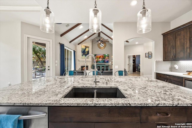 26815 Duet Dr, San Antonio, TX 78260 - kitchen with dark brown cabinetry, vaulted ceiling, a ceiling fan, open floor plan, and decorative backsplash