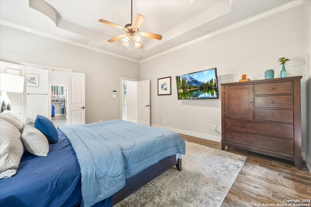 26815 Duet Dr, San Antonio, TX 78260 - bedroom with a raised ceiling, wood finished floors, crown molding, a walk in closet, and ceiling fan