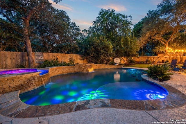 26815 Duet Dr, San Antonio, TX 78260 - pool at dusk featuring a fenced backyard and an in-ground hot tub