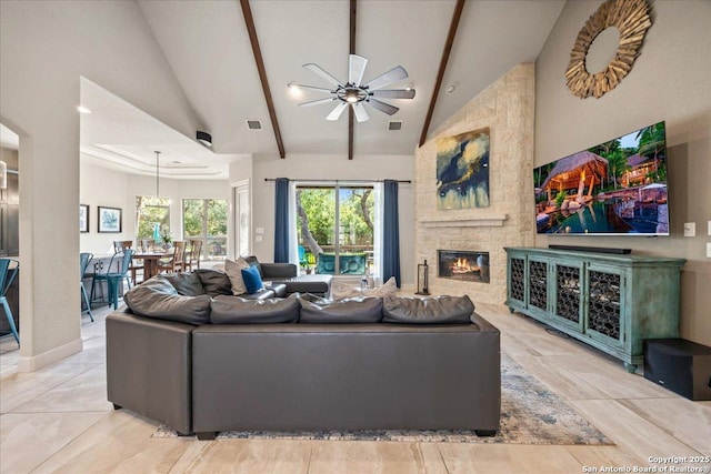 26815 Duet Dr, San Antonio, TX 78260 - living area featuring ceiling fan, beamed ceiling, a stone fireplace, and high vaulted ceiling