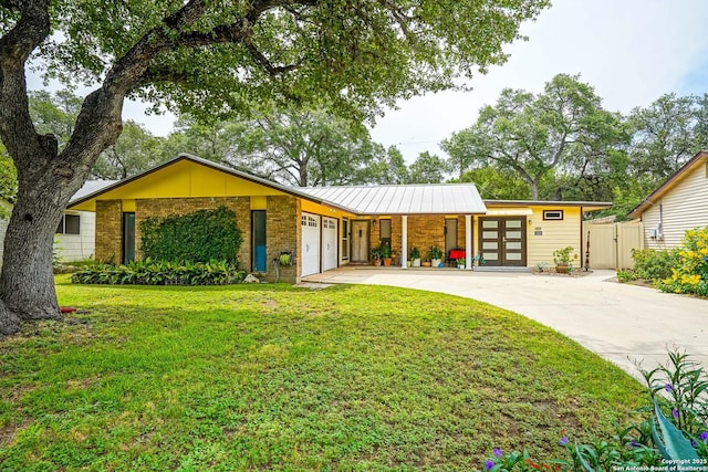 9518 Wahada, San Antonio, TX 78217 - mid-century inspired home with a garage, concrete driveway, brick siding, a standing seam roof, and a gate