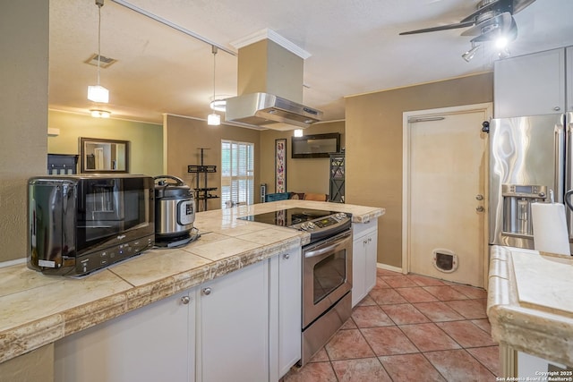 9518 Wahada, San Antonio, TX 78217 - kitchen featuring appliances with stainless steel finishes, white cabinets, ceiling fan, light tile patterned floors, and pendant lighting