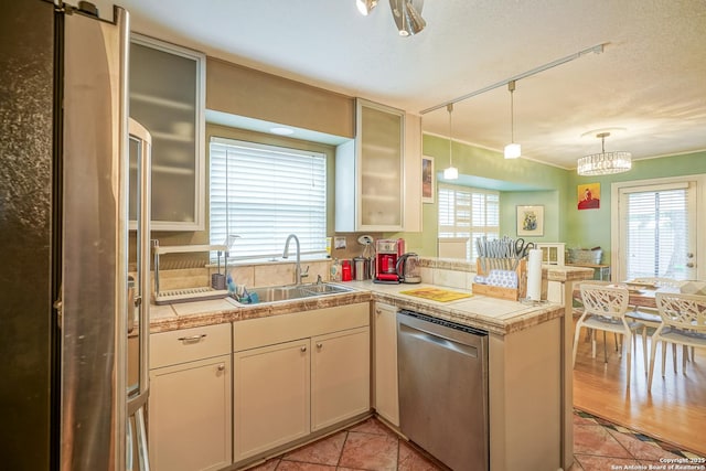 9518 Wahada, San Antonio, TX 78217 - kitchen featuring stainless steel appliances, a peninsula, hanging light fixtures, and light tile patterned floors