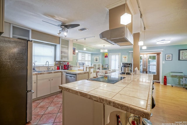 9518 Wahada, San Antonio, TX 78217 - kitchen featuring stainless steel appliances, ceiling fan, a textured ceiling, white cabinetry, and glass insert cabinets