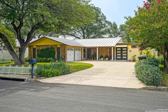9518 Wahada, San Antonio, TX 78217 - mid-century modern home featuring a standing seam roof, an attached garage, brick siding, driveway, and a metal roof