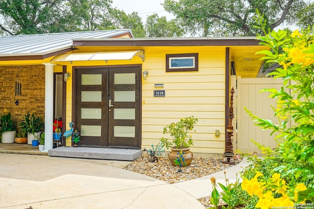 9518 Wahada, San Antonio, TX 78217 - doorway to property featuring french doors, a metal roof, and a standing seam roof