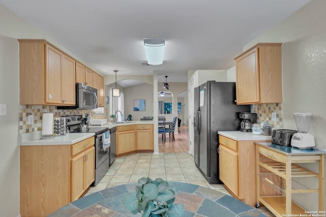 9427 Hacienda Acres, San Antonio, TX 78245 - kitchen featuring stainless steel appliances, light brown cabinets, a peninsula, and backsplash
