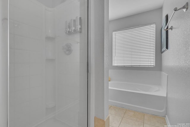9427 Hacienda Acres, San Antonio, TX 78245 - bathroom with a stall shower, tile patterned flooring, and a bath