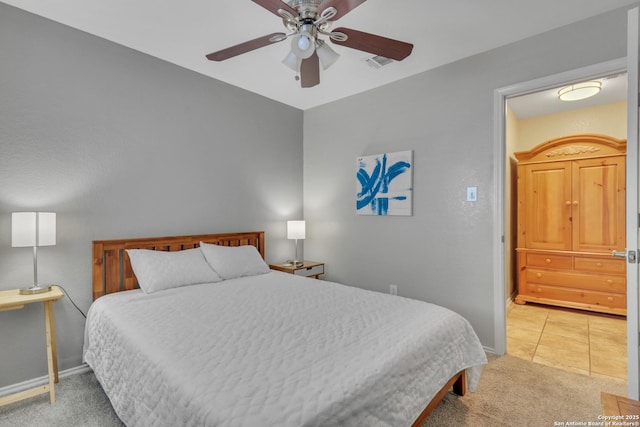 9427 Hacienda Acres, San Antonio, TX 78245 - bedroom featuring light carpet, a ceiling fan, and light tile patterned floors