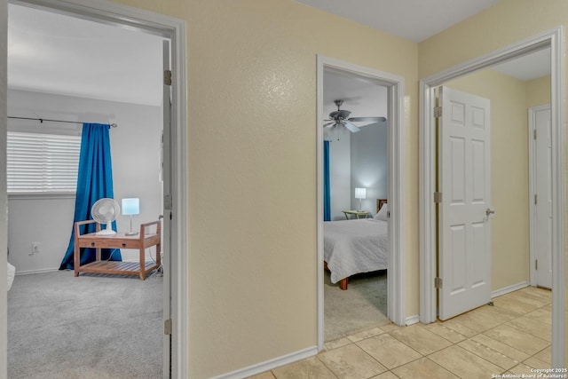 9427 Hacienda Acres, San Antonio, TX 78245 - hallway featuring light carpet and light tile patterned flooring