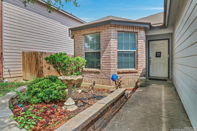 9427 Hacienda Acres, San Antonio, TX 78245 - view of exterior entry featuring brick siding