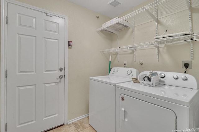 9427 Hacienda Acres, San Antonio, TX 78245 - laundry room featuring washer and dryer and light tile patterned floors