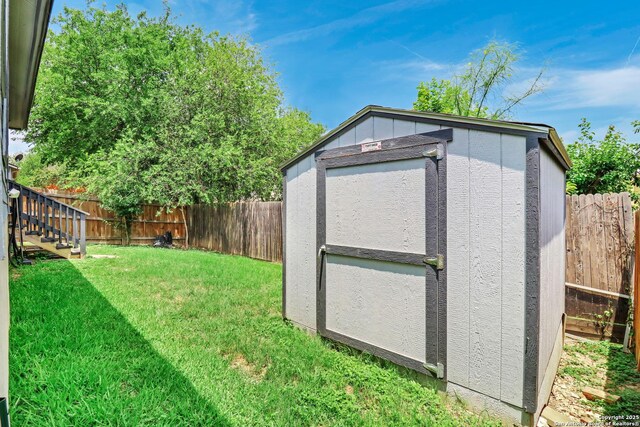 9427 Hacienda Acres, San Antonio, TX 78245 - view of shed featuring a fenced backyard and stairway