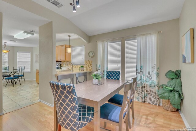 9427 Hacienda Acres, San Antonio, TX 78245 - dining room with light wood-type flooring and lofted ceiling