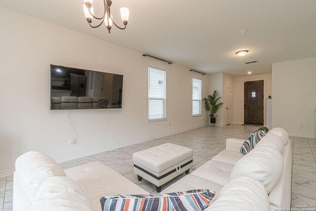 8298 Assumption Dr, San Antonio, TX 78254 - living area with light marble finish flooring and a chandelier