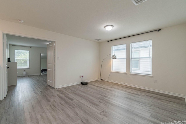 8298 Assumption Dr, San Antonio, TX 78254 - empty room featuring light wood-type flooring and a smoke detector