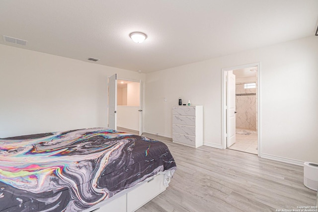 8298 Assumption Dr, San Antonio, TX 78254 - bedroom with light wood-type flooring and ensuite bathroom