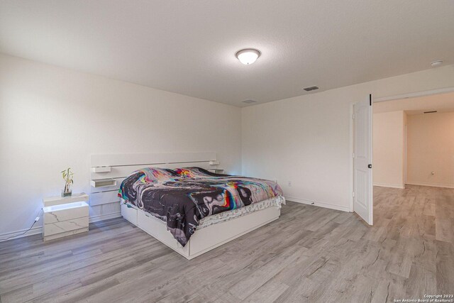8298 Assumption Dr, San Antonio, TX 78254 - bedroom featuring light wood-style floors and baseboards