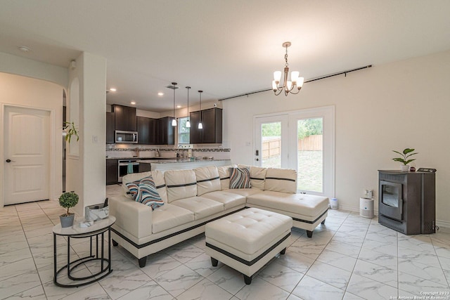 8298 Assumption Dr, San Antonio, TX 78254 - living area with light marble finish flooring, recessed lighting, a chandelier, and arched walkways