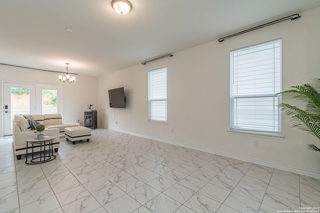 8298 Assumption Dr, San Antonio, TX 78254 - living room featuring a chandelier and light marble finish floors