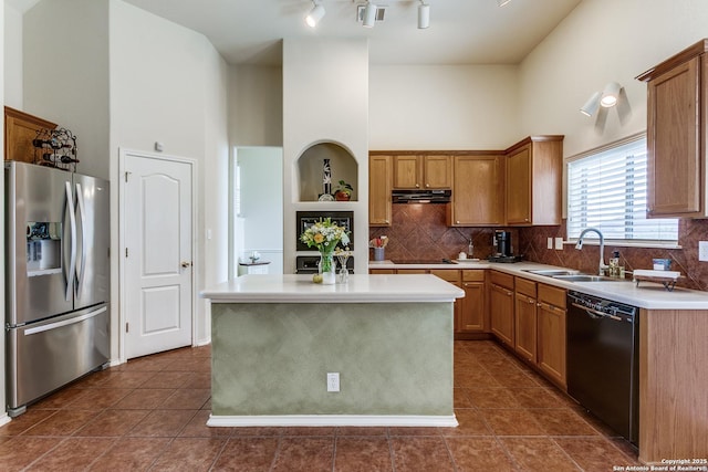 20927 Las Lomas Blvd, San Antonio, TX 78258 - kitchen with black appliances, ventilation hood, a towering ceiling, tasteful backsplash, and dark tile patterned floors