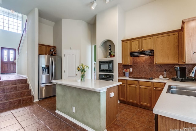 20927 Las Lomas Blvd, San Antonio, TX 78258 - kitchen with black appliances, under cabinet range hood, a towering ceiling, backsplash, and light countertops