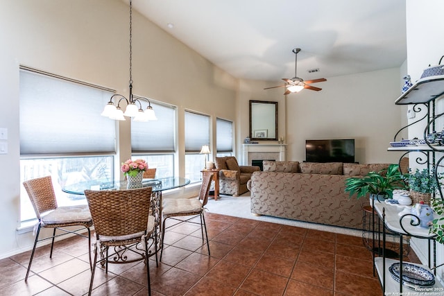 20927 Las Lomas Blvd, San Antonio, TX 78258 - dining area with tile patterned flooring, a chandelier, ceiling fan, and a tile fireplace