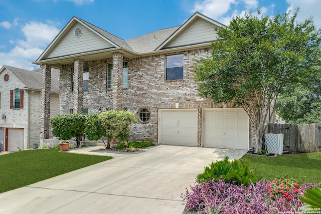 20927 Las Lomas Blvd, San Antonio, TX 78258 - view of front of house with driveway, brick siding, a garage, and roof with shingles