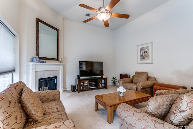 20927 Las Lomas Blvd, San Antonio, TX 78258 - living area featuring light colored carpet, a tiled fireplace, and a ceiling fan