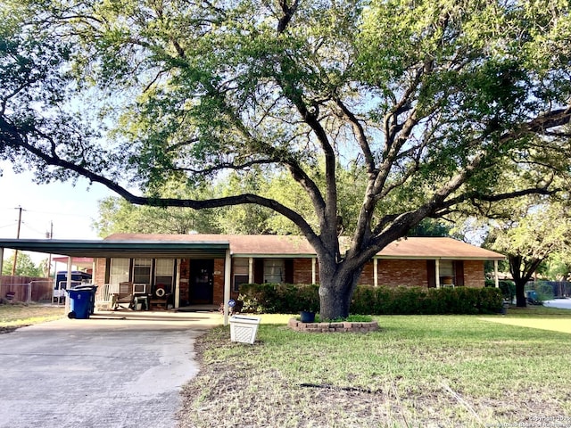 404 Alta, Pleasanton, TX 78064 - single story home with concrete driveway, an attached carport, a front lawn, and brick siding