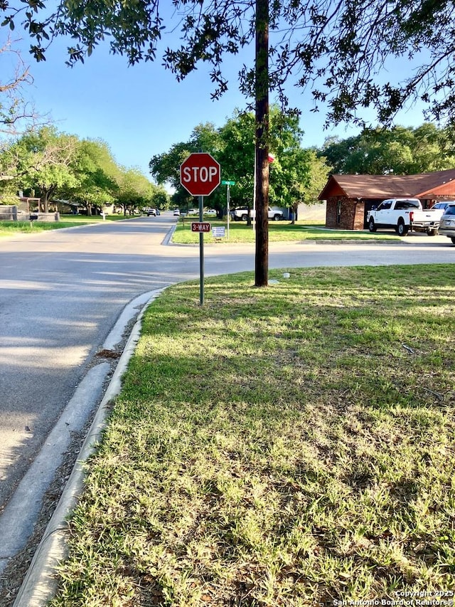 404 Alta, Pleasanton, TX 78064 - view of asphalt road featuring traffic signs