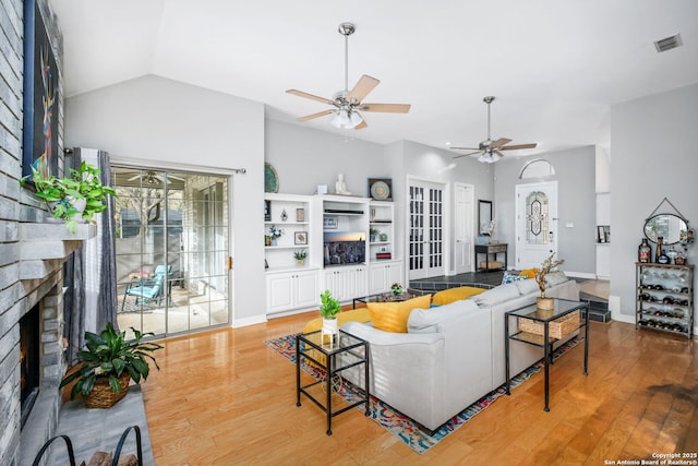 109 Trailcrest, Hollywood Park, TX 78232 - living room with a ceiling fan, a fireplace, wood finished floors, and vaulted ceiling