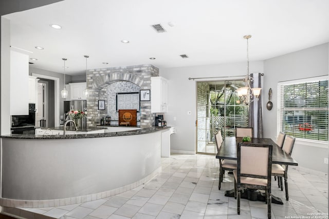 109 Trailcrest, Hollywood Park, TX 78232 - kitchen with a chandelier, dark stone counters, decorative backsplash, recessed lighting, and freestanding refrigerator