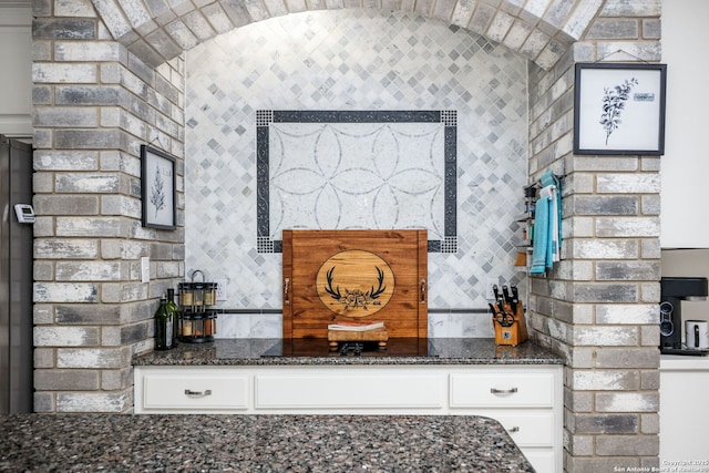 109 Trailcrest, Hollywood Park, TX 78232 - detailed view of white cabinetry, dark stone countertops, and decorative backsplash