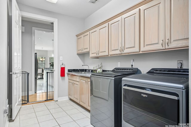 109 Trailcrest, Hollywood Park, TX 78232 - washroom with washer and clothes dryer, cabinet space, and light tile patterned floors