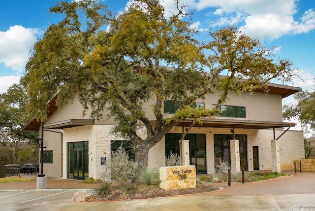 109 Trailcrest, Hollywood Park, TX 78232 - rear view of house featuring stone siding and uncovered parking