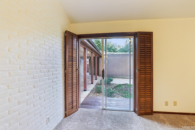 12010 Arms Way, Live Oak, TX 78233 - doorway to outside with carpet and brick wall