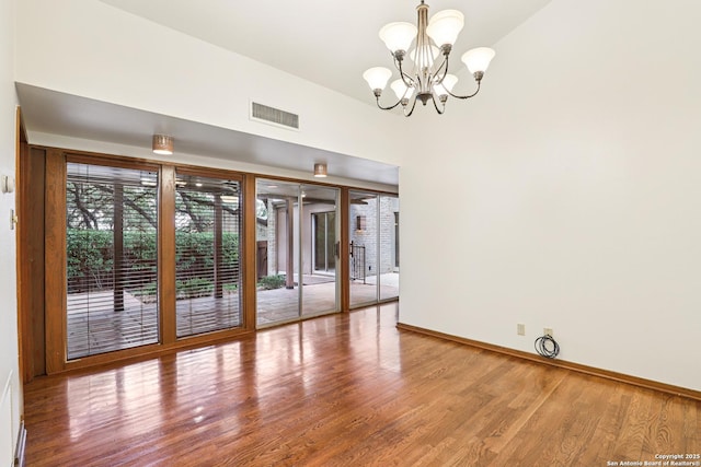 12010 Arms Way, Live Oak, TX 78233 - empty room featuring a chandelier and wood finished floors