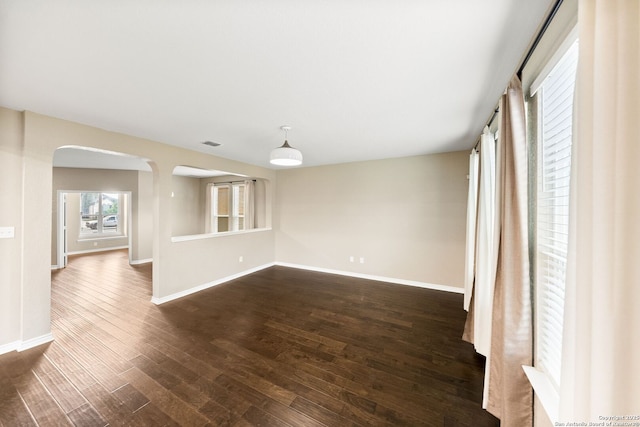 11406 Sawyer Vly, San Antonio, TX 78254 - empty room with arched walkways and dark wood finished floors