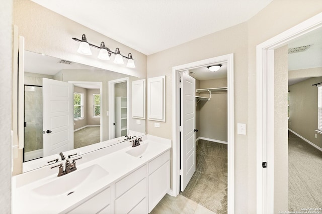 11406 Sawyer Vly, San Antonio, TX 78254 - full bathroom featuring a walk in closet, double vanity, and a shower with door