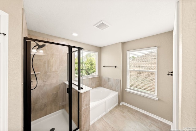 11406 Sawyer Vly, San Antonio, TX 78254 - bathroom featuring a garden tub, a stall shower, and tile patterned floors