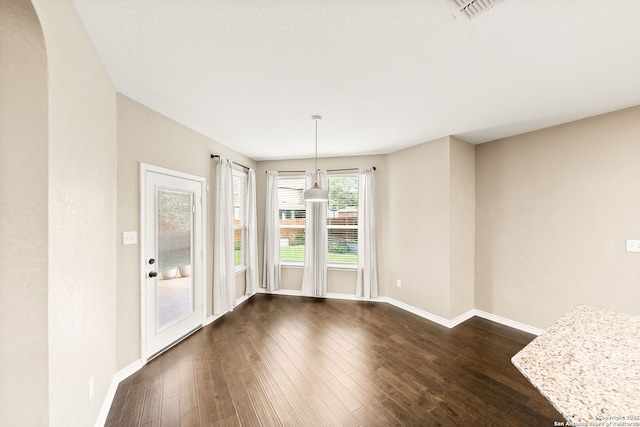 11406 Sawyer Vly, San Antonio, TX 78254 - unfurnished dining area with baseboards and dark wood-style flooring