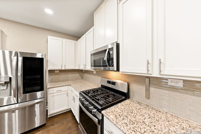 11406 Sawyer Vly, San Antonio, TX 78254 - kitchen featuring stainless steel appliances, decorative backsplash, white cabinets, light stone countertops, and dark wood-type flooring
