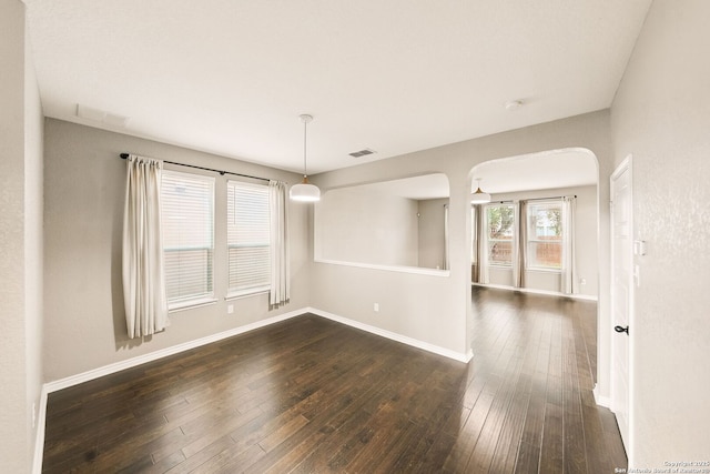 11406 Sawyer Vly, San Antonio, TX 78254 - empty room featuring dark wood-style floors, arched walkways, and a smoke detector