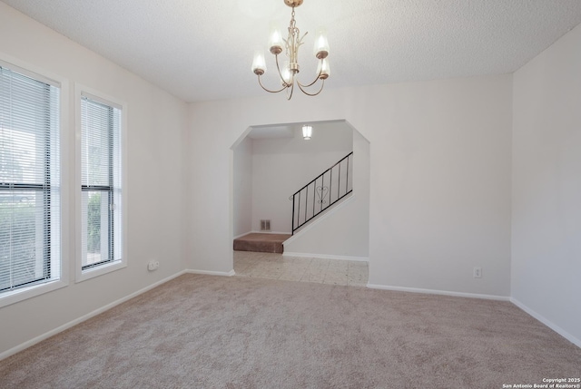 6403 Port Royal, San Antonio, TX 78244 - empty room with arched walkways, carpet, a chandelier, stairs, and a textured ceiling