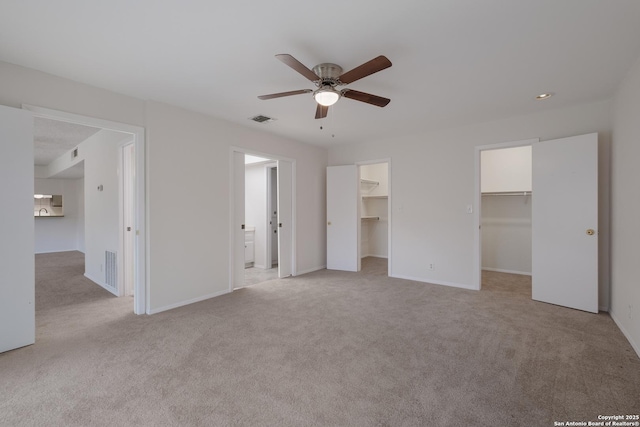 6403 Port Royal, San Antonio, TX 78244 - unfurnished bedroom featuring light carpet, a walk in closet, connected bathroom, and ceiling fan