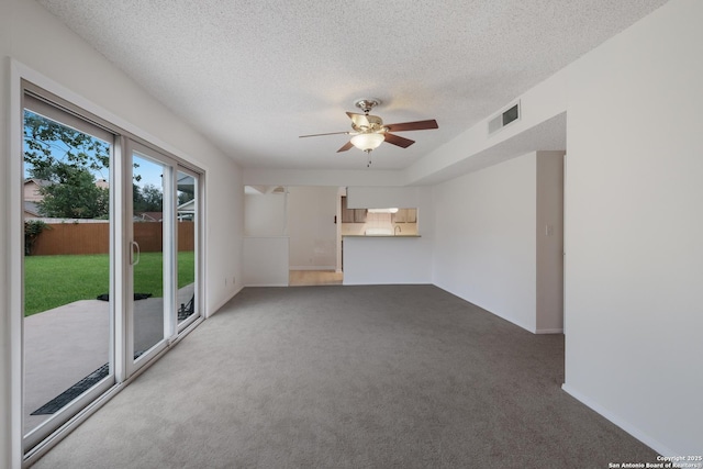 6403 Port Royal, San Antonio, TX 78244 - unfurnished living room with ceiling fan, carpet floors, and a textured ceiling