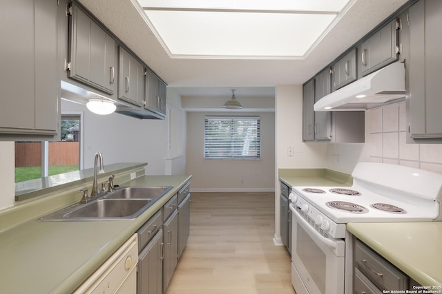 6403 Port Royal, San Antonio, TX 78244 - kitchen featuring electric stove, under cabinet range hood, light wood-style flooring, gray cabinets, and healthy amount of natural light