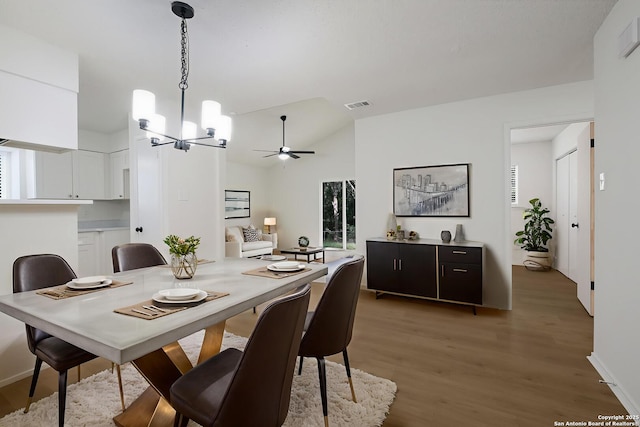 4204 Golden Spice Dr, San Antonio, TX 78222 - dining space featuring a chandelier, light wood-style floors, lofted ceiling, and a ceiling fan